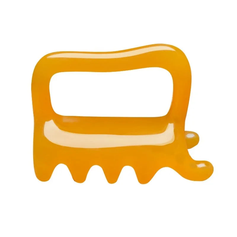 Natural resin spine meridian scraping plate 97x70mm in Amber Brown colour on white background