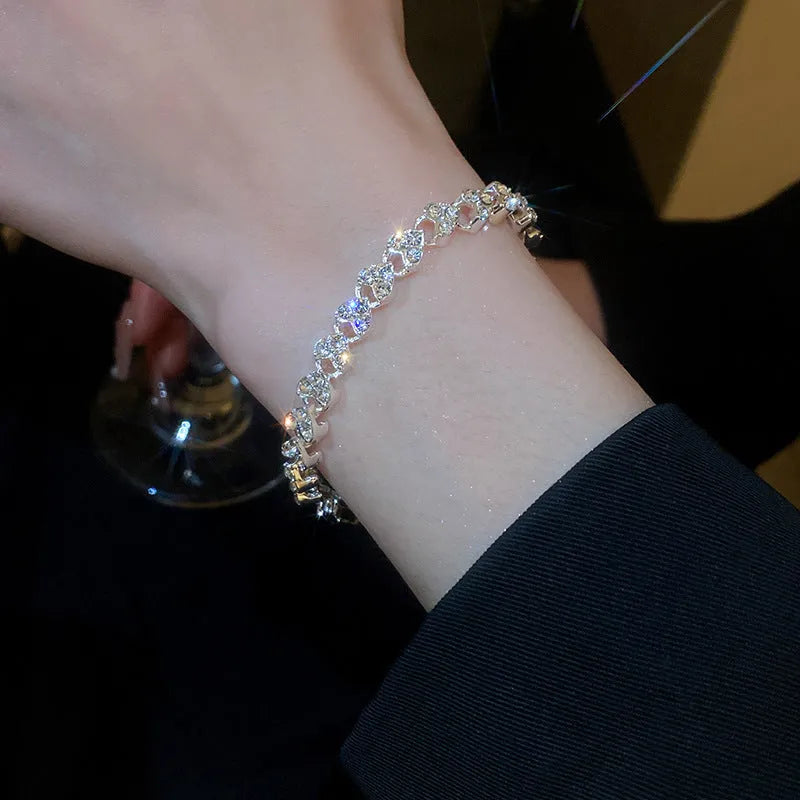 Silver heart shaped metal bracelet with inlaid zircon stones for women