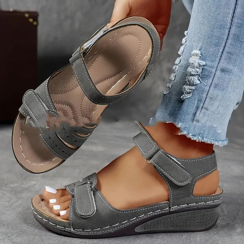 Beige wide fit sandals with thick composite sole and adjustable Velcro straps on a white background.