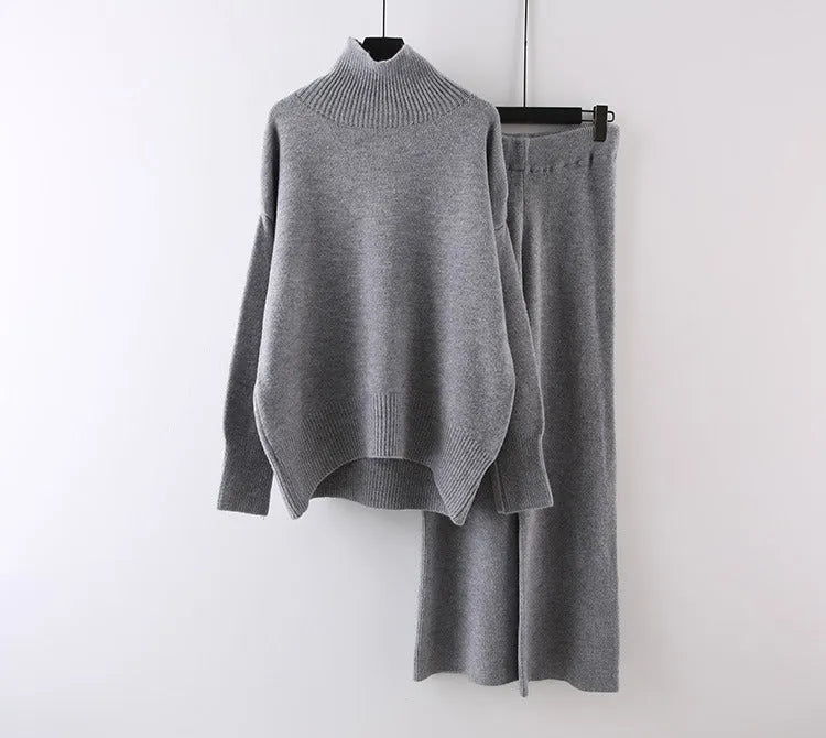 Women's beige acrylic sweater and wide-leg trousers casual two-piece set on a hanger.