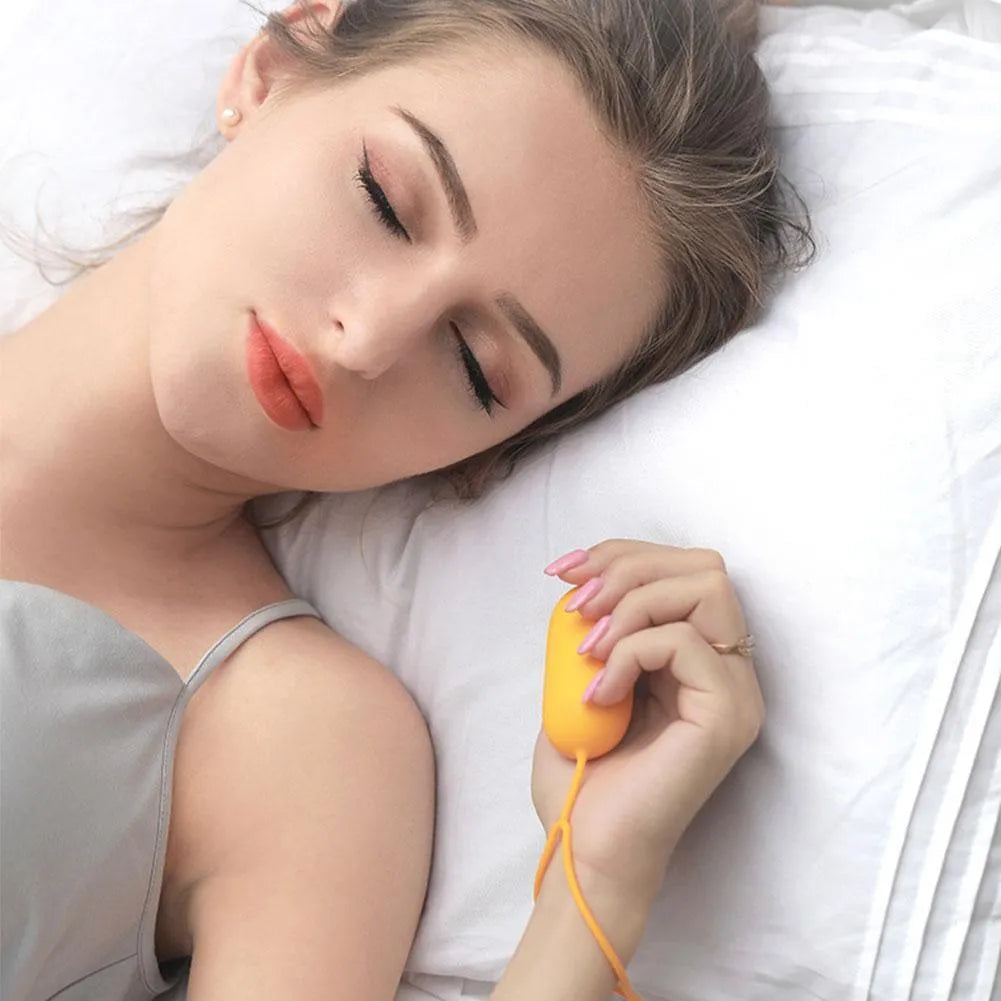 Handheld microcurrent sleep aid device with round button, USB charging port, and stainless steel electrodes in grey green orange colours