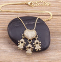Gold colour copper heart pendant necklace with zircon inlays on white background