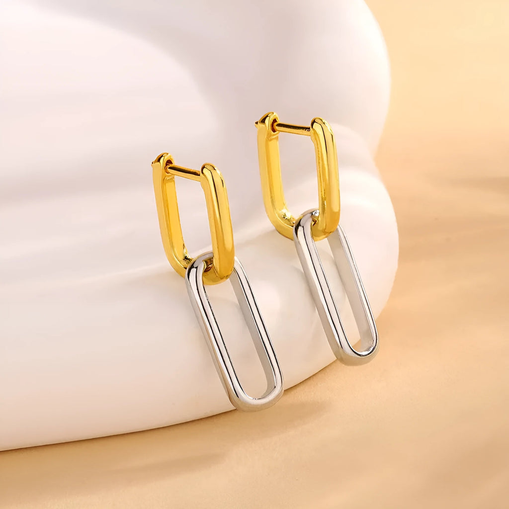 14K gold and silver two-tone geometric U-shaped earrings on a light background showing the copper core and metallic finish