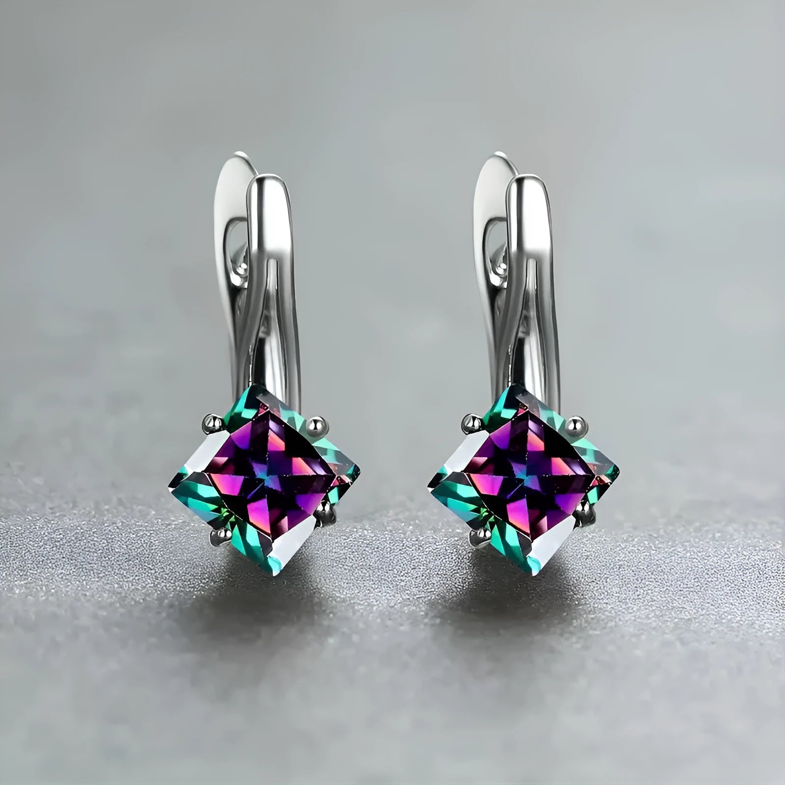 A pair of women's copper earrings with a diamond design featuring inlaid blue zircon stones.