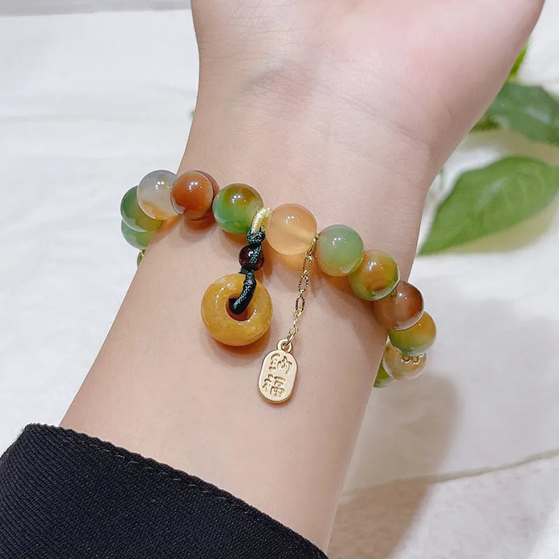 Yellow peacock agate women's bracelet with peace buckle closure measuring 1cm wide