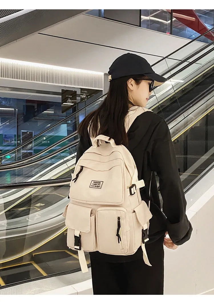 Black and white nylon student backpack with laptop compartment and 3D pockets.