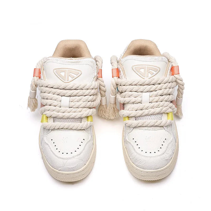 Creamy white retro low-top skateboard shoes with a platform sole and lace-up fastening.