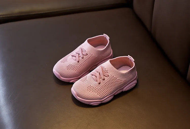 Children's white lazy slip-on shoe with fabric upper and textured non-slip rubber sole.