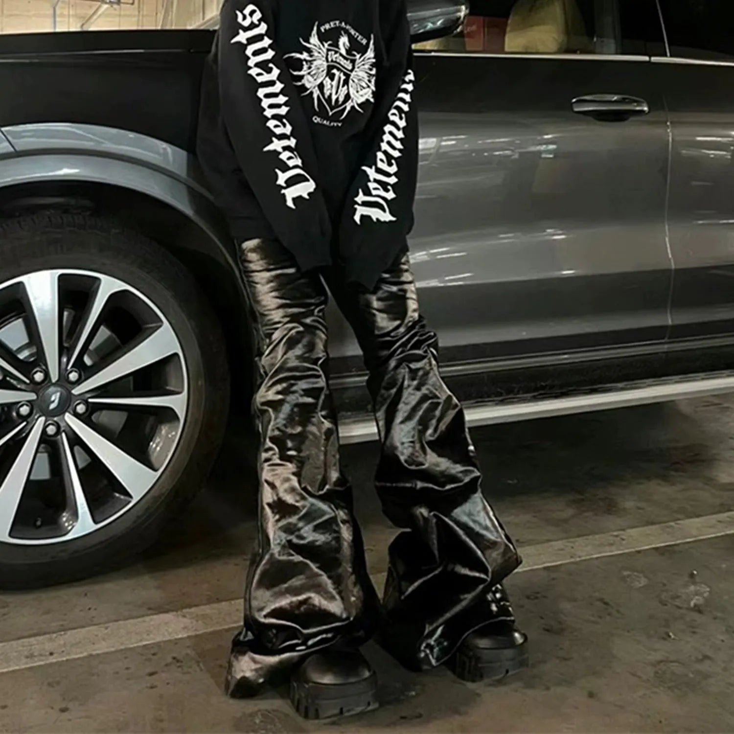 Black shiny patent leather skinny jeans with a straight-leg cut and mid waist