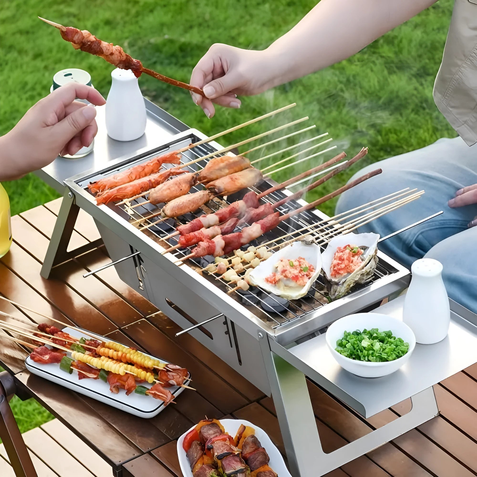 Small foldable portable steel charcoal grill for outdoor use.