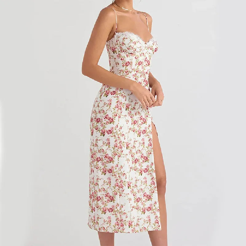 Women's blue lace flowers print long dress with suspender straps and a side slit on a model.