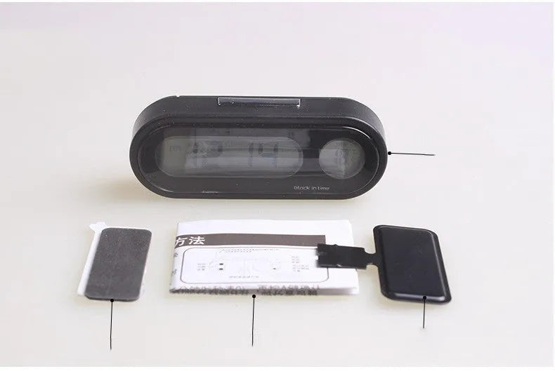Black electronic car clock and thermometer on an adjustable bracket with luminous LED display.