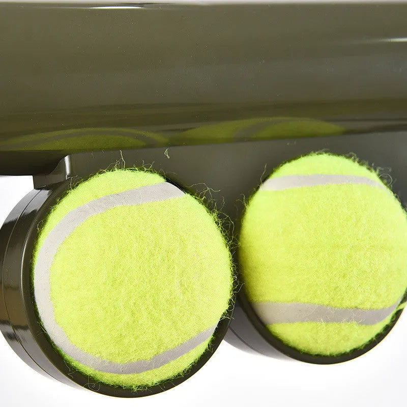 Black tennis shooting gun pet toy with two tennis balls measuring 65.5 cm long