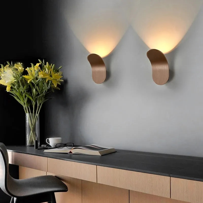 Modern simple wall lamp in brushed gold finish mounted on living room wall
