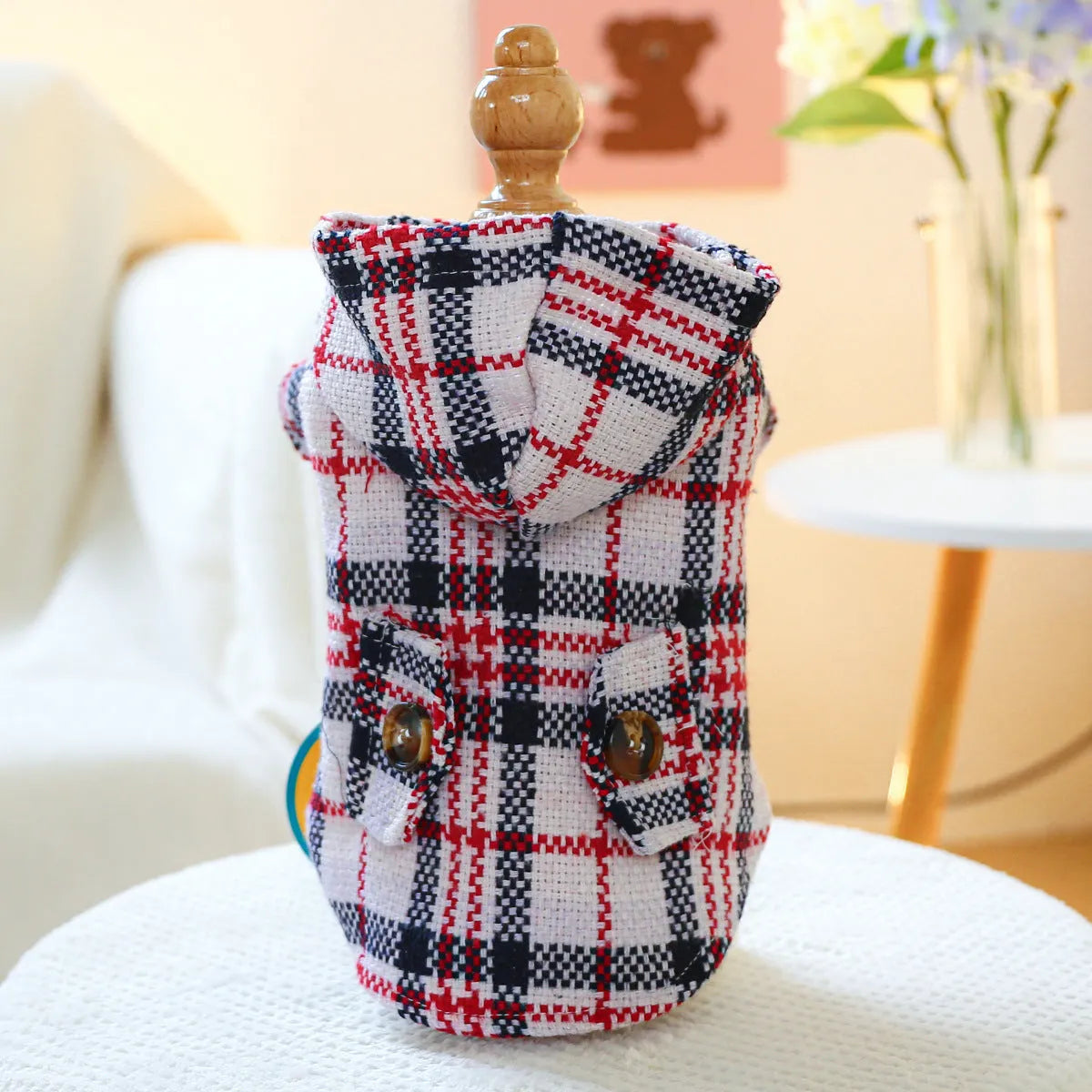 Red plaid dog trench coat shown alongside black houndstooth version, with size chart showing chest circumference measurements