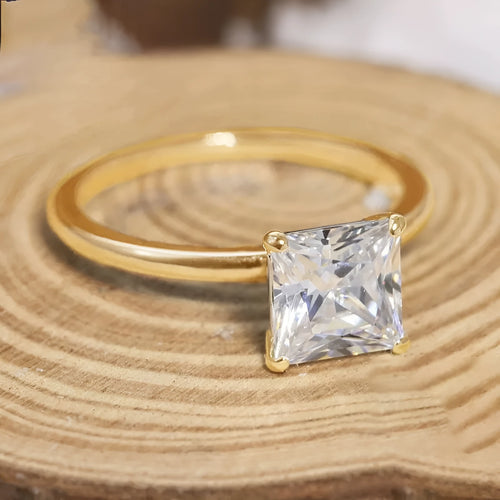 Women's geometric sterling silver ring in gold, rose gold, or silver on a grey background.