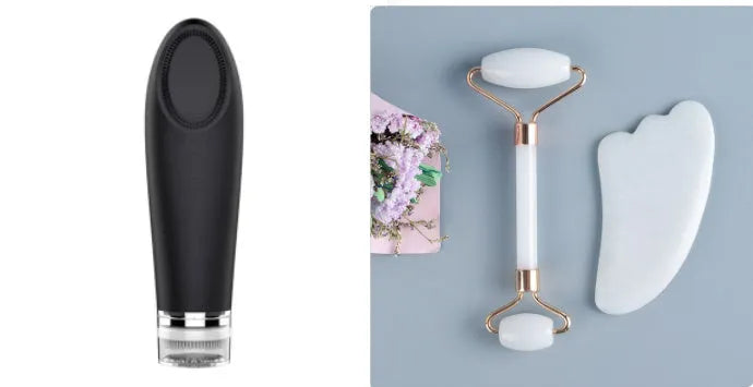 White jade facial roller and gua sha scraping tool set presented on a wooden board.