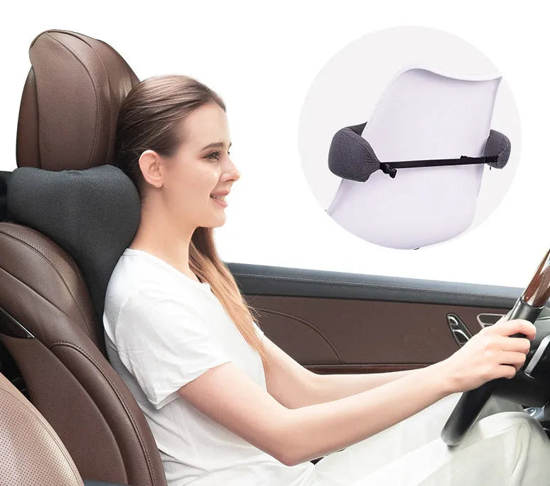 Dark grey memory foam car headrest pillow shown on car seat, measuring 67x10x27.5 cm.