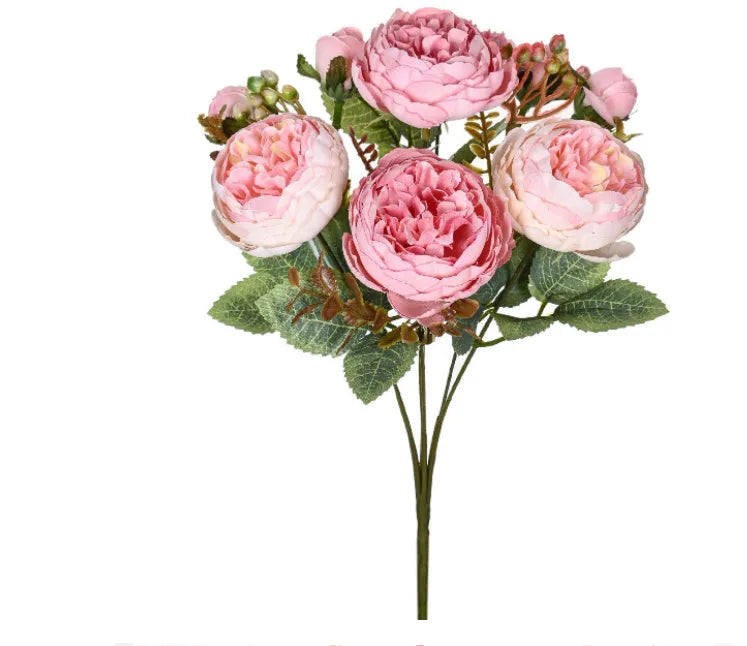 Artificial silk peony bouquet in champagne colour on a table.