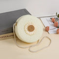 Woven raffia crossbody bag in beige with floral pattern, showing 16cm diameter for phone carrying