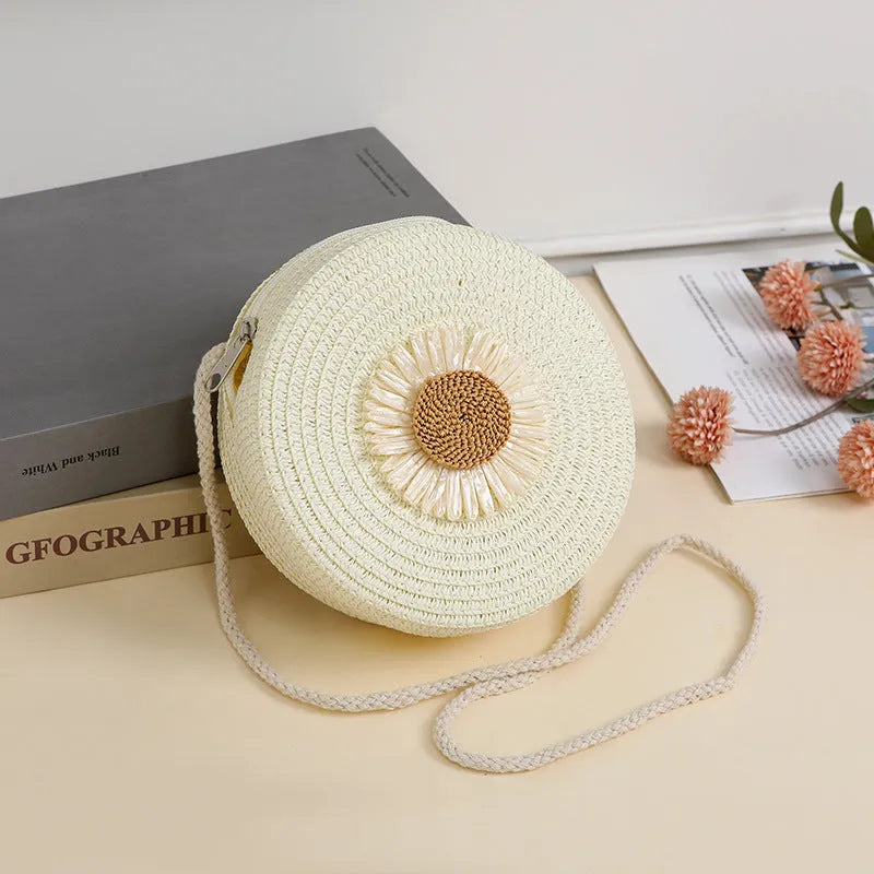 Woven raffia crossbody bag in beige with floral pattern, showing 16cm diameter for phone carrying