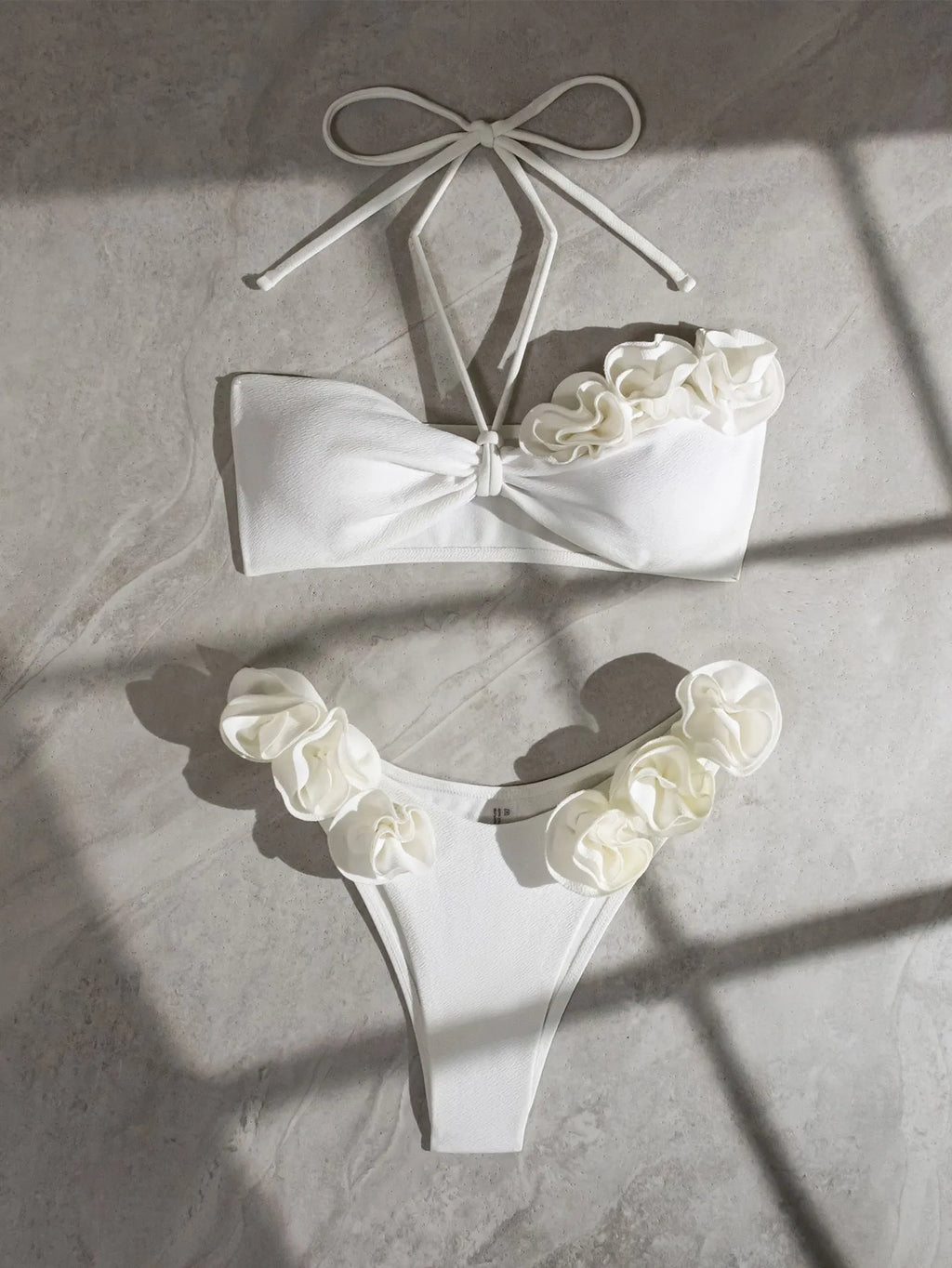 White halter neck lace-up bikini with split-cup design and three-dimensional floral details
