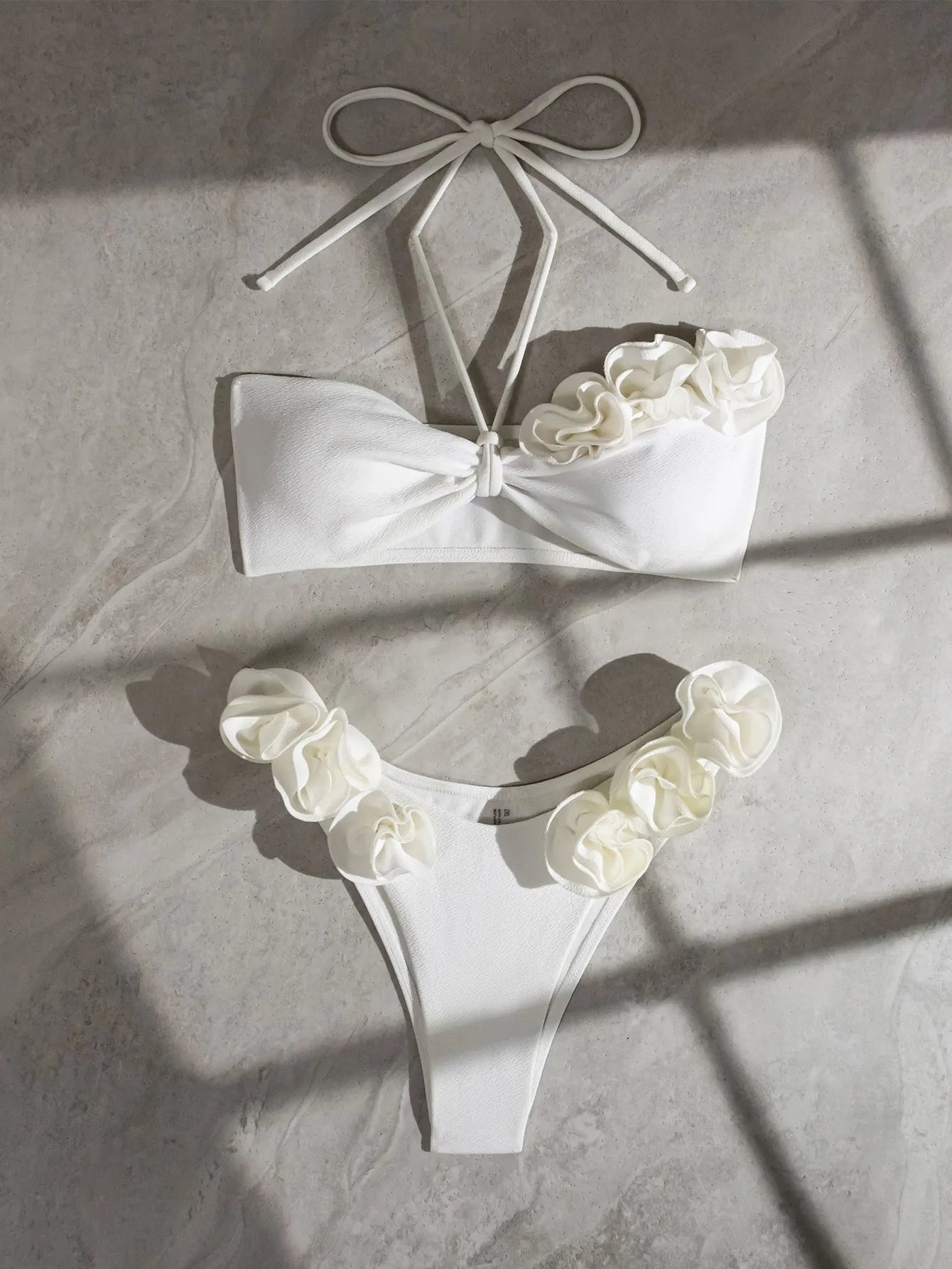 White halter neck lace-up bikini with split-cup design and three-dimensional floral details
