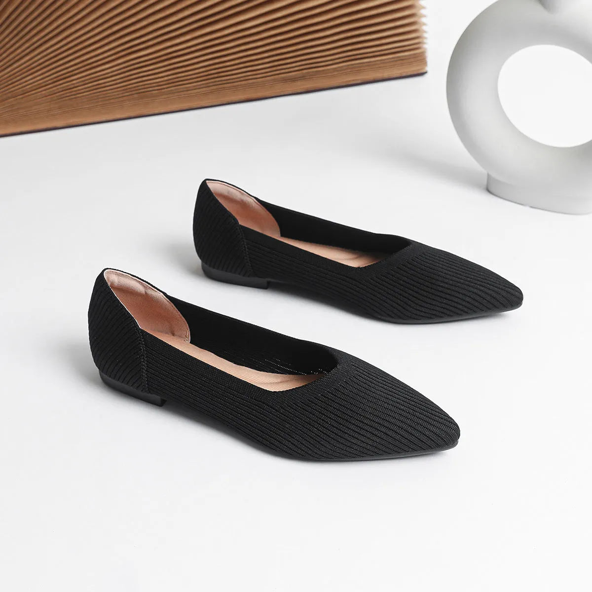 Women's knit flat pumps with pointed toe and rubber sole available in multiple colours