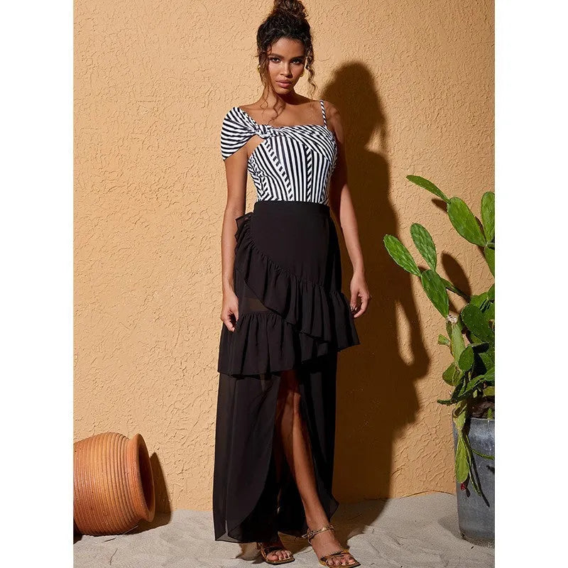 Women's striped one-piece swimsuit with black ruffled skirt detail for swimming and beachwear