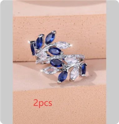 Adjustable copper leaf-shaped ring with a Horse Eye Zircon stone, shown in a rose gold finish.