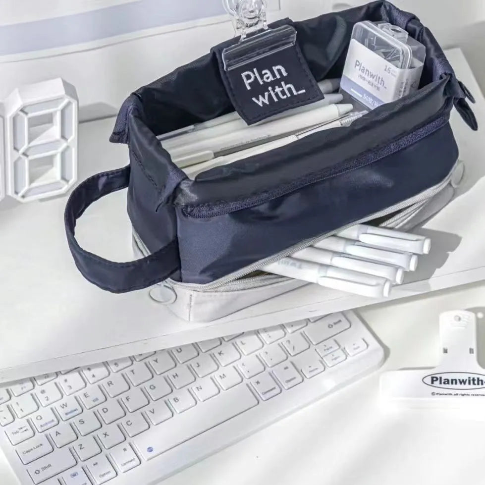 Folding double layer student pencil case in navy blue, blue, and cream white colours made from polyester.