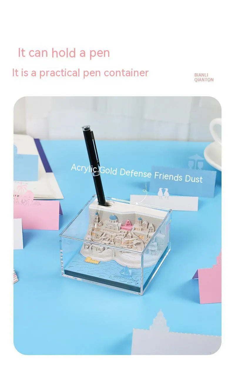 Assembled Santorini beach 3D paper model notepad with decorative lighting on a desk.