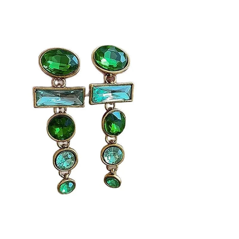 A pair of green gradient geometric drop earrings with inlaid zircon stones and a dangling tassel detail.
