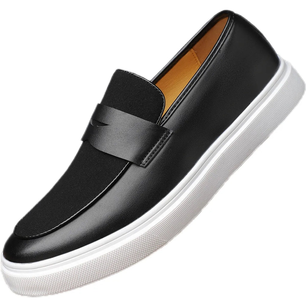 Black men's slip-on loafers with tassel detail and rubber sole, shown in profile view