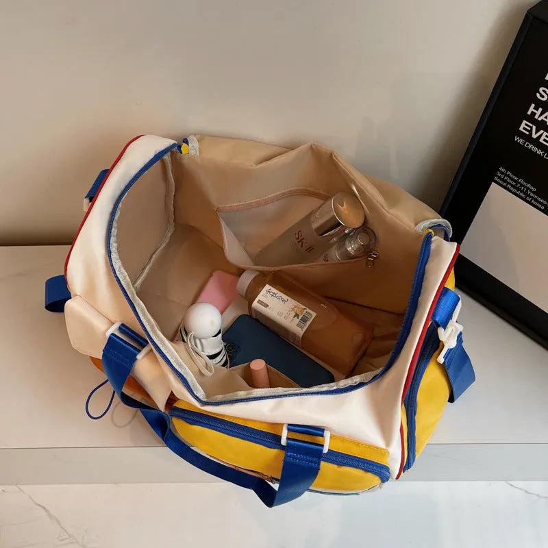 Fashion colour contrast multi-pocket cloth travel bag with blue and white accents on a plain background