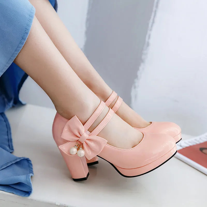 Red women's chunky heel platform shoes with a round toe and buckle fastening on a rubber sole.