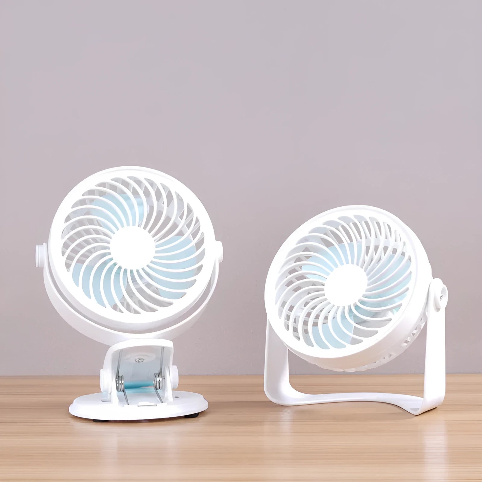 Mini USB desk fan with clip attachment and three blades, shown in desktop setting.