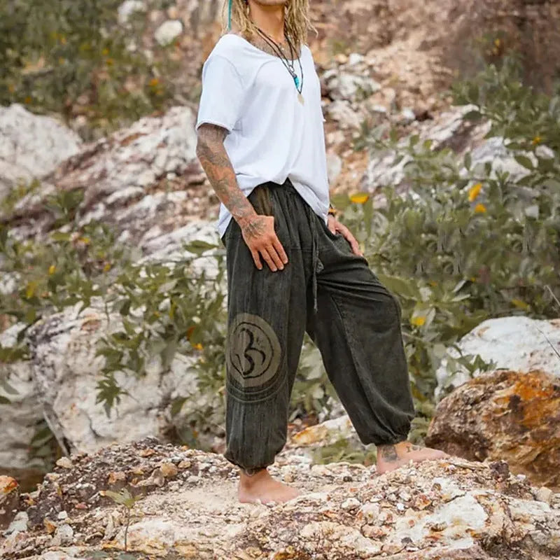 Dark green men's trousers with ethnic pattern and ankle tie detail, mid waist fit