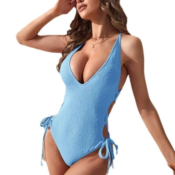 Women's black hollow backless tether bikini one-piece swimsuit on a mannequin.