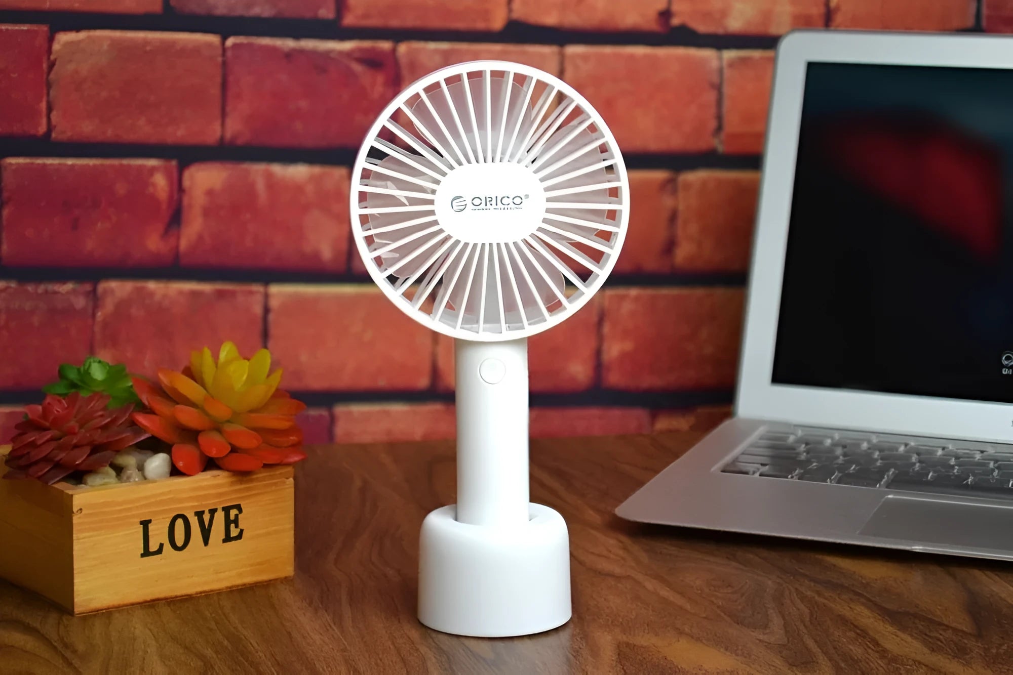 White ORICO FH1 portable USB rechargeable desk fan on a table