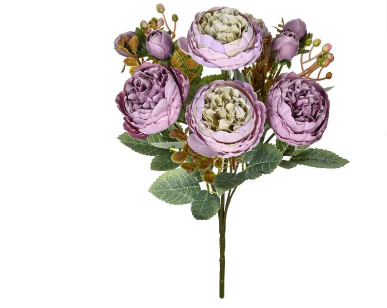 Artificial silk peony bouquet in champagne colour on a table.