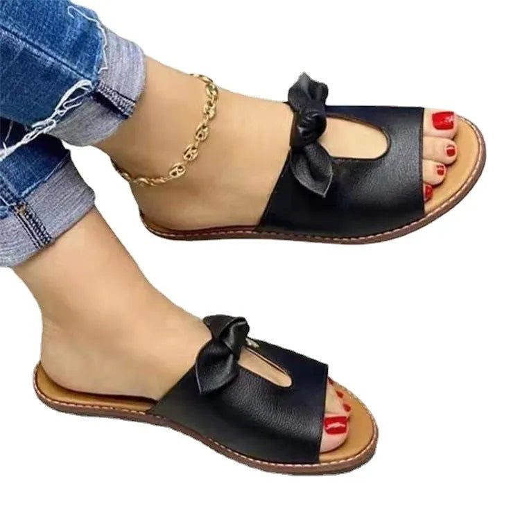 Ladies fish mouth sandals with a decorative bow on the upper, shown in black, pink, and gold colours.