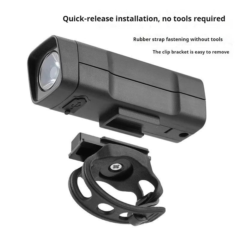 Black USB rechargeable bicycle headlight with quick release strap bracket on handlebars