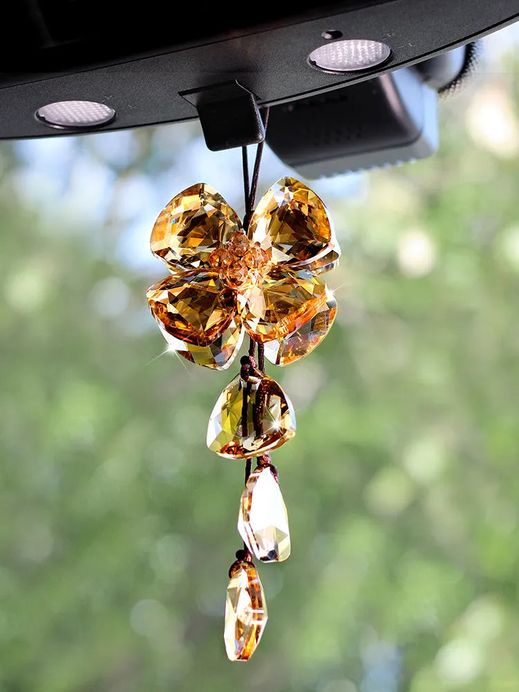 Crystal four leaf clover car pendant hanging, approximately 20 cm long, on a transparent background.