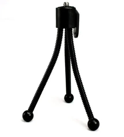 Compact aluminium mini tripod with ball head, shown contracted to 110mm height next to a smartphone.