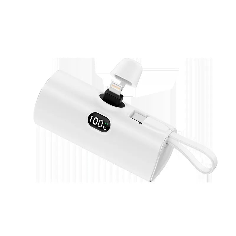 Compact capsule‑shaped digital display power bank with integrated plug, shown in multiple colours.