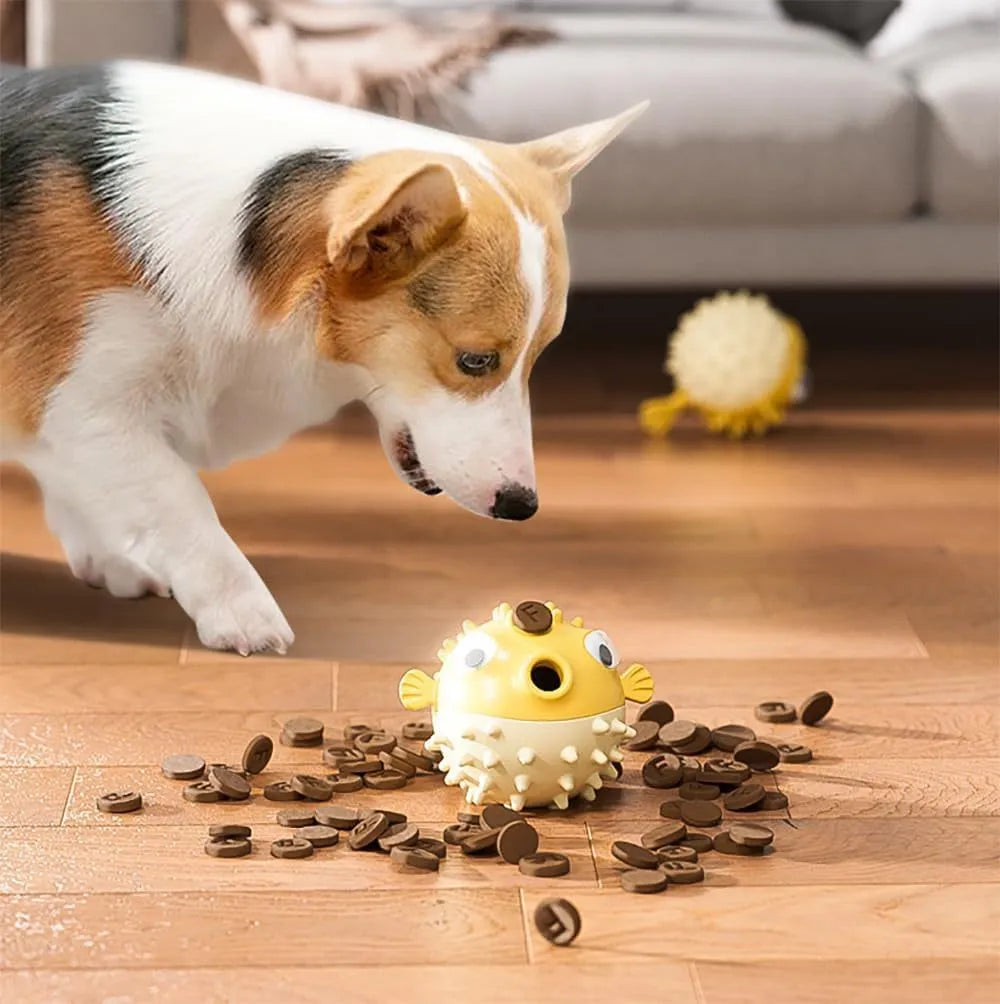 Green fish-shaped interactive dog chew toy with treat-dispensing hole and textured surface.