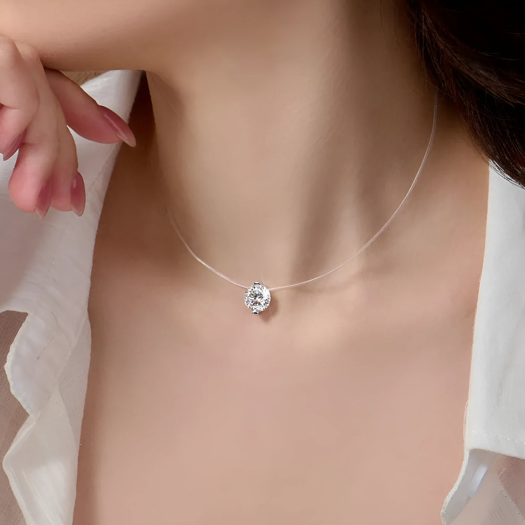 Close-up of a women's sterling silver necklace with a floating moissanite pendant and plum blossom detail.
