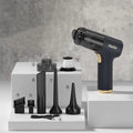 Black wireless handheld car vacuum cleaner with attachments including brushes and nozzles.