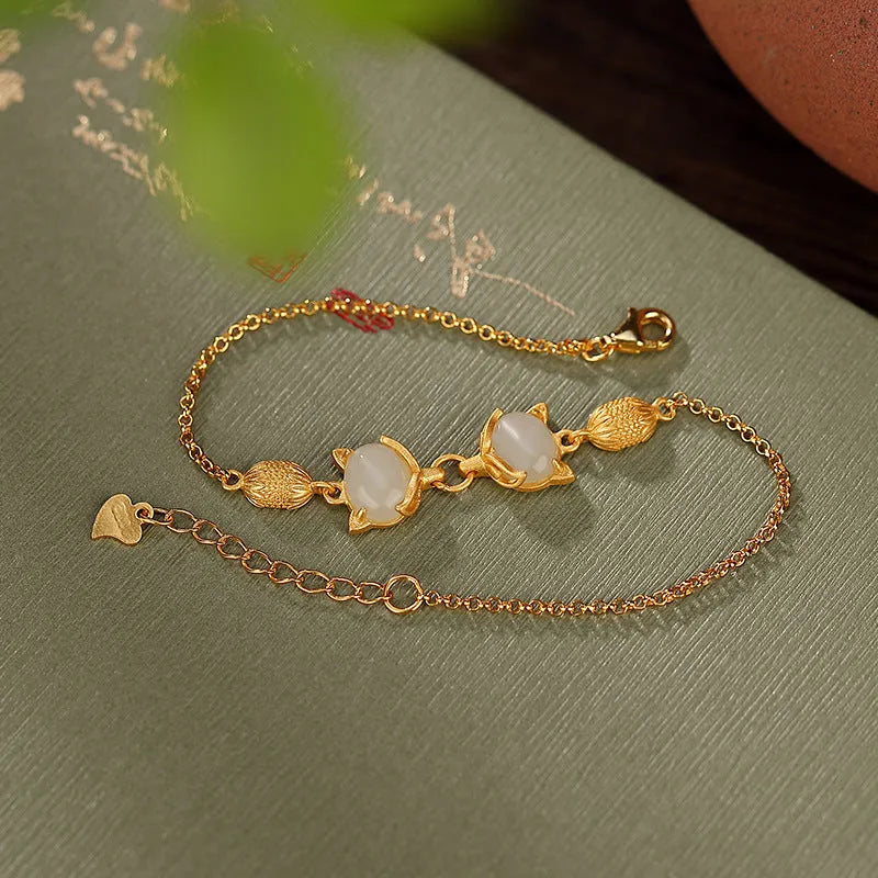 Close-up of a women's 925 silver bracelet with a hand-carved fox charm on an adjustable chain.